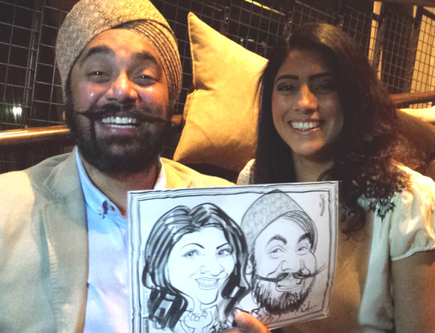 Guests with their caricature by Chris Murphy at Malmaison Hotel, Liverpool.